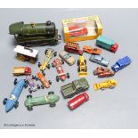 A mixed group of toy cars and an engine (railway)