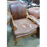An 18th century style tan leather elbow chair, width 70cm, depth 64cm, height 105cm