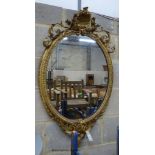 A Victorian giltwood and gesso oval wall mirror, width 58cm, height 100cm