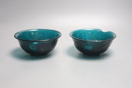 A pair of Chinese Beijing green glass bowls, Qianlong four character and of the period (1736-95)