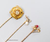 A Victorian diamond set gold target stickpin, another with pearl and diamond and a third with red