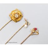 A Victorian diamond set gold target stickpin, another with pearl and diamond and a third with red