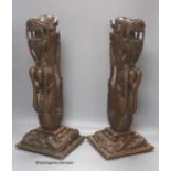 A pair of Burmese carved hardwood 'dragon' lamps, height 50cm, lacking light fittings