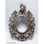 A 19th century Italian carved walnut oval picture frame, 41 x 30cm.