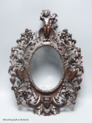 A 19th century Italian carved walnut oval picture frame, 41 x 30cm.