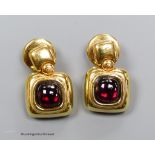 A pair of '750' and cabochon garnet earrings, gross 10g.