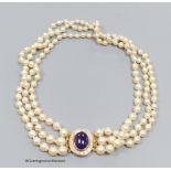 A three strand cultured pearl necklace with cabochon amethyst and diamond set 18ct gold clasp,