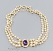 A three strand cultured pearl necklace with cabochon amethyst and diamond set 18ct gold clasp,