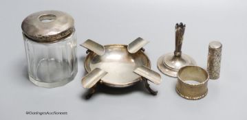 Small silver - a topped hair tidy, an ashtray, London 1900, 3.3oz., a napkin ring, a white metal