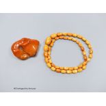 A string of amber beads and a specimen piece of Baltic amber