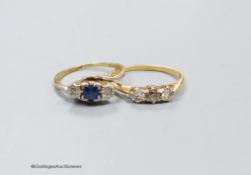 A three stone diamond ring, size M, 2.4g, and a three stone diamond and sapphire ring, size O, 2.