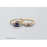 A three stone diamond ring, size M, 2.4g, and a three stone diamond and sapphire ring, size O, 2.