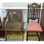 A Victorian carved oak "Glastonbury" chair and a carolean style oak carved dining chair (2)