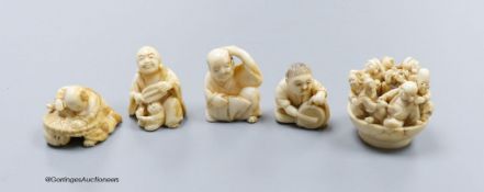 Five Japanese carved ivory netsukes, Meiji period, including an example of the seven gods of