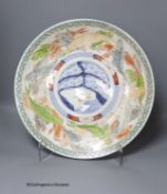 A 19th century Japanese Imari charger,decorated in pale colours with a band of swimming carp