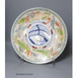 A 19th century Japanese Imari charger,decorated in pale colours with a band of swimming carp