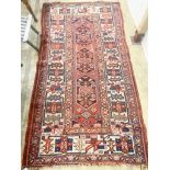 A Caucasian red ground rug, 218 x 112cm