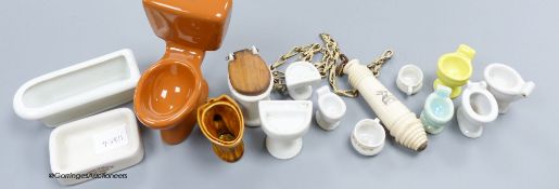 A group of various miniature models of toilets and a pull chain