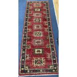 A Caucasian style red ground runner, 240 x 80cm