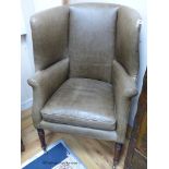 A Regency barrel back wing armchair upholstered in pale green leather