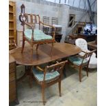 A reproduction mahogany twin pillar extending dining table and a set of six Regency fruitwood caned