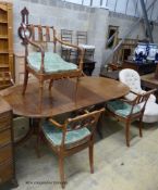 A reproduction mahogany twin pillar extending dining table and a set of six Regency fruitwood caned