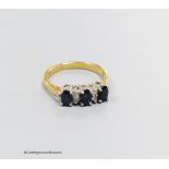 An 18ct gold sapphire and diamond dress ring, size N, gross 3.4g.