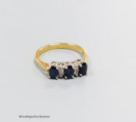 An 18ct gold sapphire and diamond dress ring, size N, gross 3.4g.