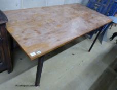 A walnut veneer and steel rectangular dining table, designed and made by Bill Gill, circa 1960,