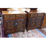 A pair of Chinese carved cabinets, the fronts carved with foliage in low relief, width 69cm, depth