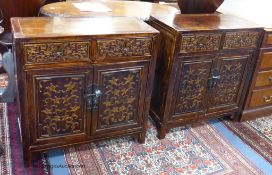 A pair of Chinese carved cabinets, the fronts carved with foliage in low relief, width 69cm, depth