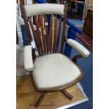 A late 19th century mahogany and cream leather swivel and rocking desk chair