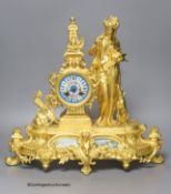 A late 19th century French gilt metal figural mantel clock, with Sevres style inserts, with key and