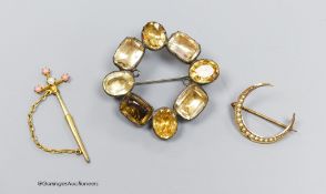 An antique silver and paste brooch, 4cm., a 9ct gold and seed pearl crescent brooch and a gilt