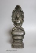 An 18th/19th century Cambodian bronze seated figure of Buddha Shakyamuni and the cobra