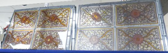 A pair of stained glass panels designed with oak leaves and Tudor roses, width 56cm height 38cm