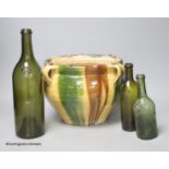 A French tin glazed pottery jardiniere and three French green glass bottles, tallest 31cm