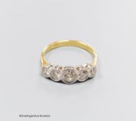 An 18ct gold five stone diamond ring, size T, gross 4.3g.Approx. 1.30ct.