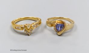 An 18ct gold and diamond dress ring, size N, gross 4.5g, and a 14k gold, diamond and tanzanite