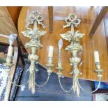 A pair of carved giltwood and gesso linenfold eagle two branch wall lights, height 70cm