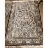 An ivory ground Persian wool rug, 200 x 130cm
