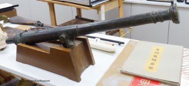 An 18th century Lantaka bronze swivel cannon, 101cm long, on a later wood stand,