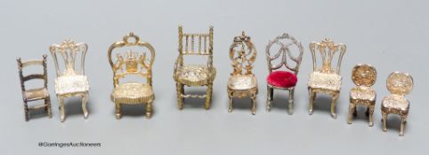 A late Victorian miniature silver model of a chair, 57mm, one other Edwardian chair, two pairs of