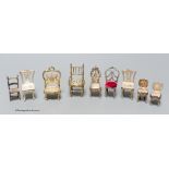 A late Victorian miniature silver model of a chair, 57mm, one other Edwardian chair, two pairs of