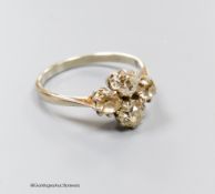 A white metal (stamped plat) and four stone diamond cluster ring, size O/P, gross 3.3 grams.