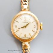 A lady's 9ct gold Omega manual wind wrist watch, on a 9ct gold bracelet, case diameter 20mm, gross