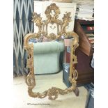 A reproduction rococo gilt mirror. W-48, H-84cm.