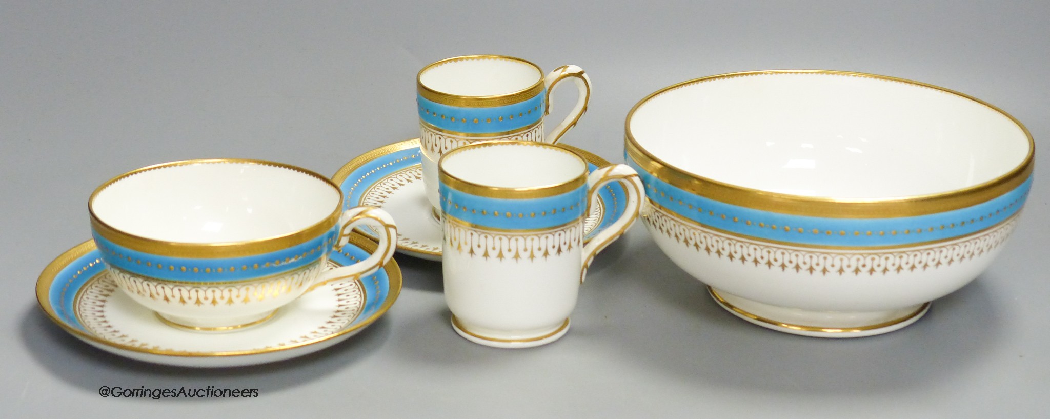 A Minton coffee cup, teacup and saucer with turquoise and gold jewelled band under a gold acid