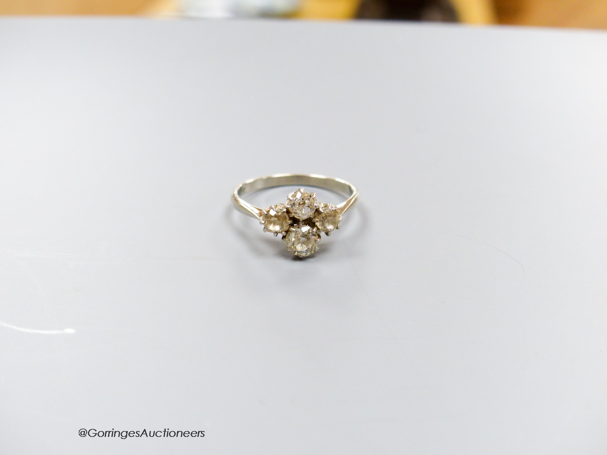 A white metal (stamped plat) and four stone diamond cluster ring, size O/P, gross 3.3 grams. - Image 3 of 4