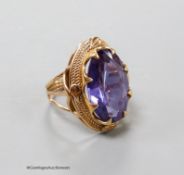 A yellow metal and synthetic colour change sapphire set oval dress ring, size O, gross 8.7 grams.